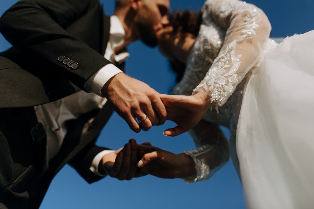 newlywed couple holding hands