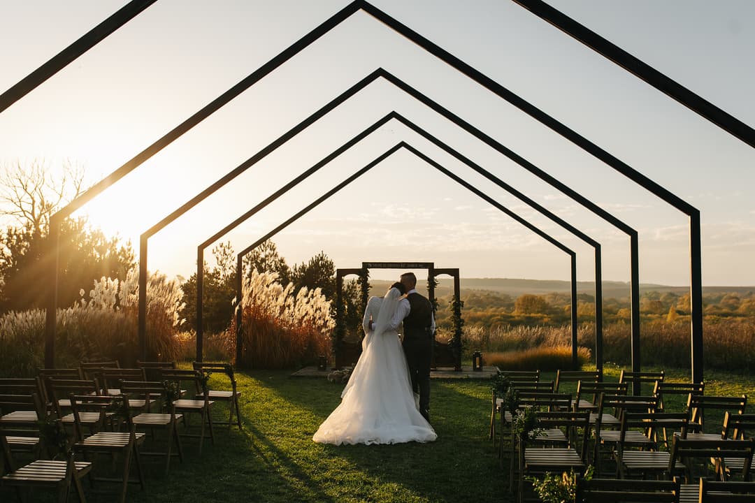 wedding couple hugging at sunset