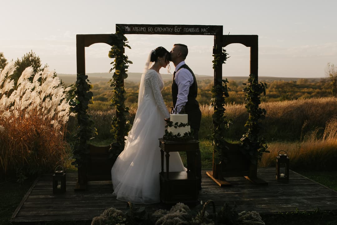 wedding couple kissing at sunset
